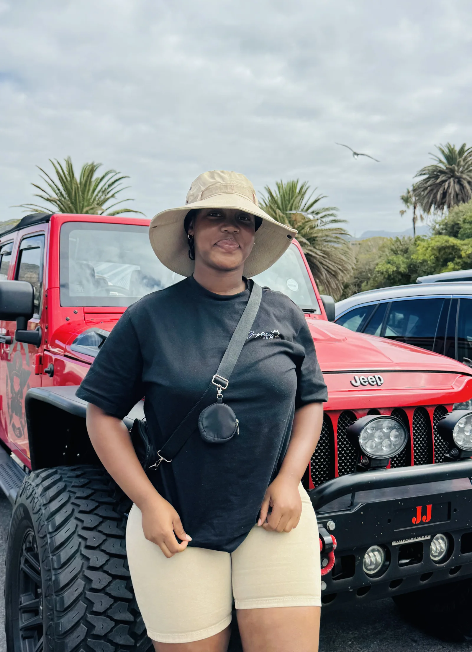 Princess, founder of Jeep Cape Xplorer, with a red Jeep